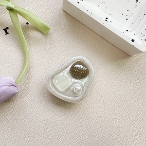 Macro detail of resin phone grip with seashell pearl and gemstone in ocean style