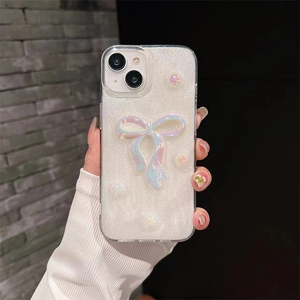 Detail of glitter iPhone case with 3D iridescent bow and delicate pearl accents