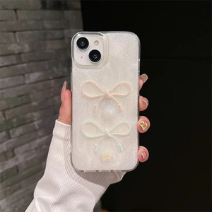 Detail of white glitter iPhone case featuring 3D bow relief and floral patterns