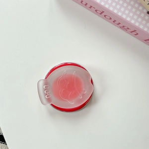 Detail of cute fish-shaped phone stand with smiley face pattern on frosted clear cover