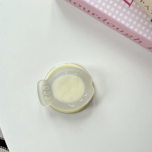 Detail of creative round solid balm container with cute smile pattern silicone lid