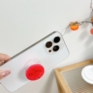 Watermelon pattern round phone socket grip on white smartphone with a transparent base