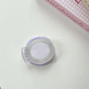 Detail of a purple round contact lens case with a minimalist cartoon graphic and matte lid