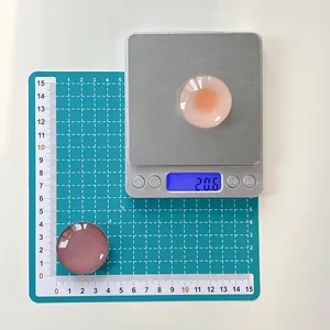 Macro view of crystal glass phone grip showing 3.5cm diameter and 20.6g weight on scale