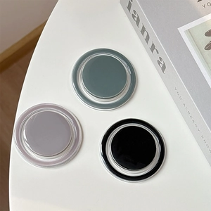 Three magnetic MagSafe phone grip stands in dark green, light grey, and black colors