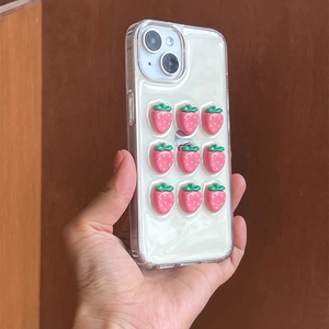 3D pink strawberry charms on creamy white iPhone case with transparent edges