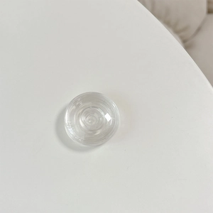 Detailed macro view of the clear crystal glass phone grip with multi-layer ring structure