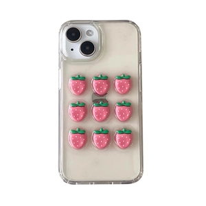 Clear iPhone case featuring 3D pink strawberry charms and green leaves decoration