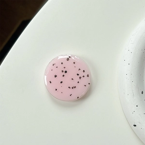 Close-up of pink terrazzo phone socket with black speckles and smooth epoxy finish