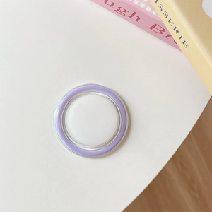 Detail shot of a lavender purple circular phone grip on a minimalist desk surface