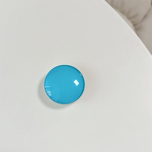 Macro detail of sky blue round crystal glass phone grip with smooth polished mirror finish