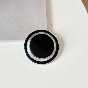 Close-up of minimalist black and silver magnetic folding phone grip with metallic frame