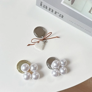 Elegant pearl heart bow phone ring holder with foldable metal grip and luxury aesthetic