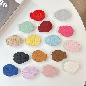 Fish-shaped leather collapsible phone grip stand in 15 vibrant colors with pebble grain finish