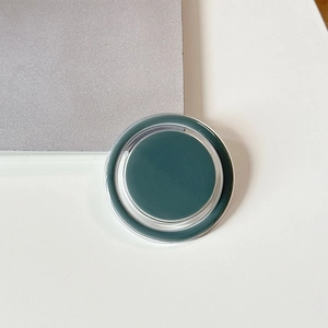 Macro view of dark green magnetic circular phone grip with transparent acrylic frame