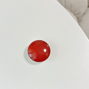 Close-up of red crystal glass phone socket with high-gloss finish on white background