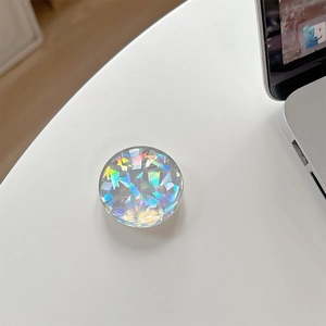 Macro detail of round crystal glass phone socket with holographic geometric pattern