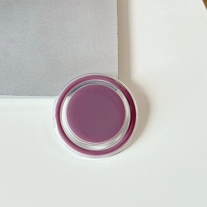 Detail view of magnetic phone grip showing berry purple paste and transparent casing