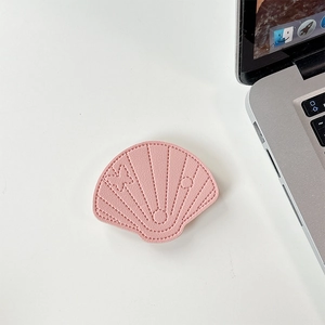 Macro detail of pink leather shell phone socket with decorative stitching and butterfly motif