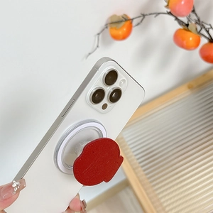 Close-up of red character phone socket on a smartphone with autumn decorative branches