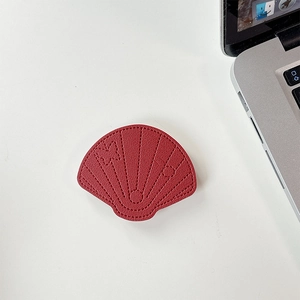 Detail of red leather shell phone grip with fine stitching and embossed patterns