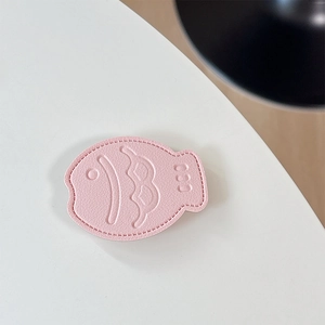 Detailed view of pink leather fish phone grip with litchi texture and fine stitching