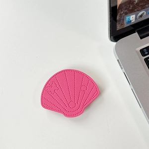 Macro shot of peach pink leather shell phone grip with litchi texture and fine stitching