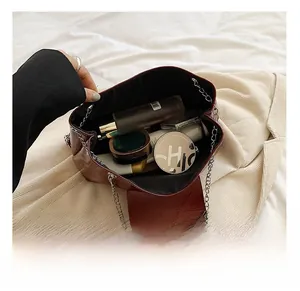 Internal capacity of dark red leather tote showing makeup items and spacious storage