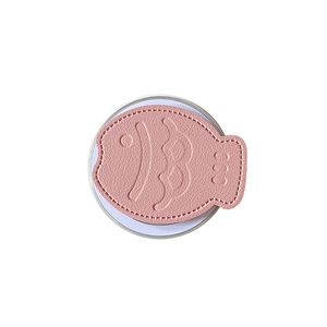 Pink leather fish-shaped phone socket grip with detailed stitching and magnetic base