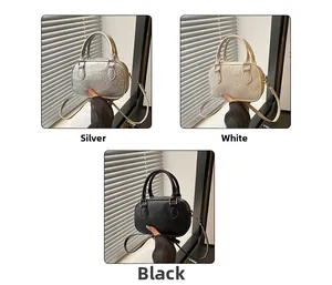 Three mini embossed handbags in silver, white and black with cartoon bear patterns