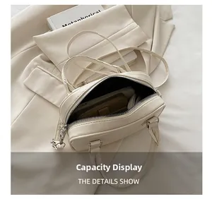 Close-up detail of cream bowling handbag showing spacious interior storage capacity