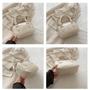 Detailed views of creamy white mini bowling bag with embossed cartoon heart patterns