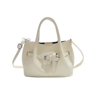 Creamy white woven bucket bag with elegant buckle detail and crossbody shoulder strap