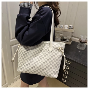 Detail of white tote bag with grey M pattern print and side adjustable drawstrings