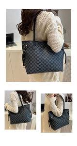 Detail of black monogram tote bag featuring golden rivets and premium leather straps