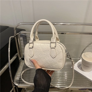 Chic white Boston handbag with cartoon embossing and adjustable strap for women