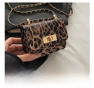 Detail showing leopard print texture with quilted stitching and gold chain strap lock