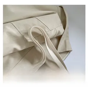 Detail of soft cream leather tote bag featuring wide comfortable shoulder straps