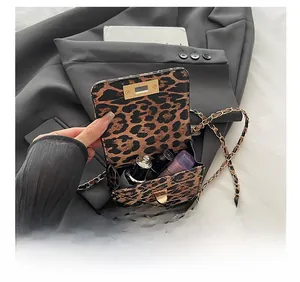 Detailed internal view showing capacity of leopard print chain bag for lipsticks