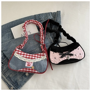 Detail of denim plaid and black-pink quilted mini handbags with lace and bow accents
