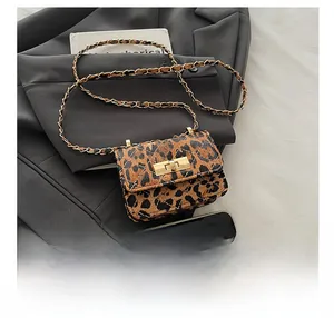 Detail showing an ultra-mini leopard print crossbody bag compared with a smartphone