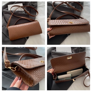 Detail of brown woven texture bag with gold twist lock and slim shoulder strap