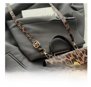 Detail of leopard print crossbody bag with gold adjustable buckle and metallic hook