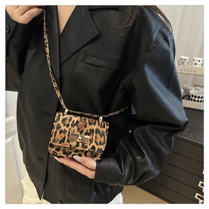 Detail of mini leopard print crossbody bag featuring quilted velvet and gold chain strap