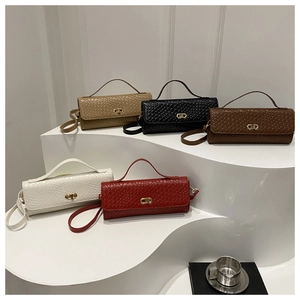 Detailed view of woven baguette handbags in five colors with gold CD buckles