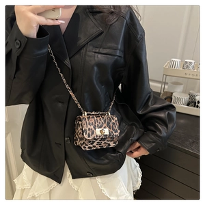 Leopard print quilted crossbody bag with gold lock and chain strap shown on model