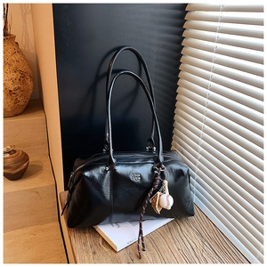 Detail of black glossy faux leather bowling bag with COIN 2DN logo and baseball charm