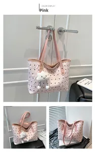 Detail of pink quilted tote bag with black butterfly patterns and cute cloud charm