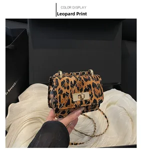 Close-up of leopard print crossbody bag with gold twist lock and quilted chain strap