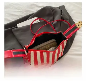 Detail showing the large interior capacity of striped canvas tote with phone and wallet